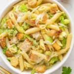 Chicken Caesar Pasta Salad in a serving bowl with lettuce and croutons