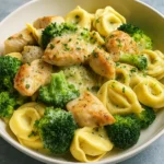 Creamy Chicken Tortellini with Broccoli served in a white bowl
