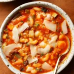 Minestrone Soup in rustic bowl with pasta and vegetables