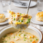 Chicken Pot Pie Soup in a bowl with bread