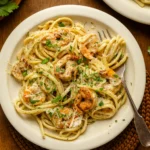 Creamy Garlic Shrimp Pasta on a plate with parmesan sauce