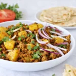 Pakistani Ground Beef and Potato Curry served with naan and rice