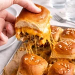 Cheeseburger Sliders baked with melted cheddar and pickles