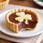 Chocolate Shamrock Pies on marble with golden shamrock toppers