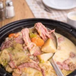creamy slow cooker corned beef and cabbage soup in a bowl