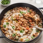 Unstuffed Peppers Skillet in cast-iron pan with melted cheese