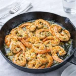 Healthy Shrimp Scampi in skillet with lemon and parsley