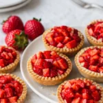 Quick Mini Strawberry Custard Tartlets on rustic tray